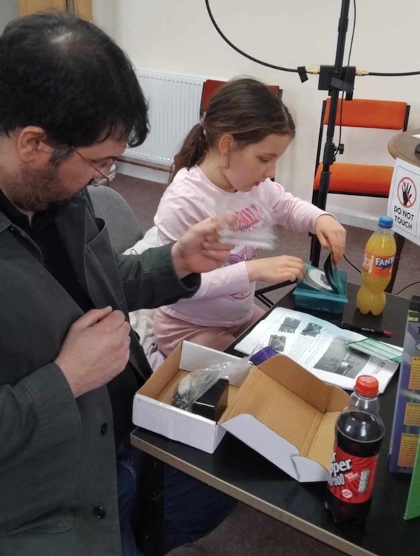 Olivia with her Dad building an electronics kit.
