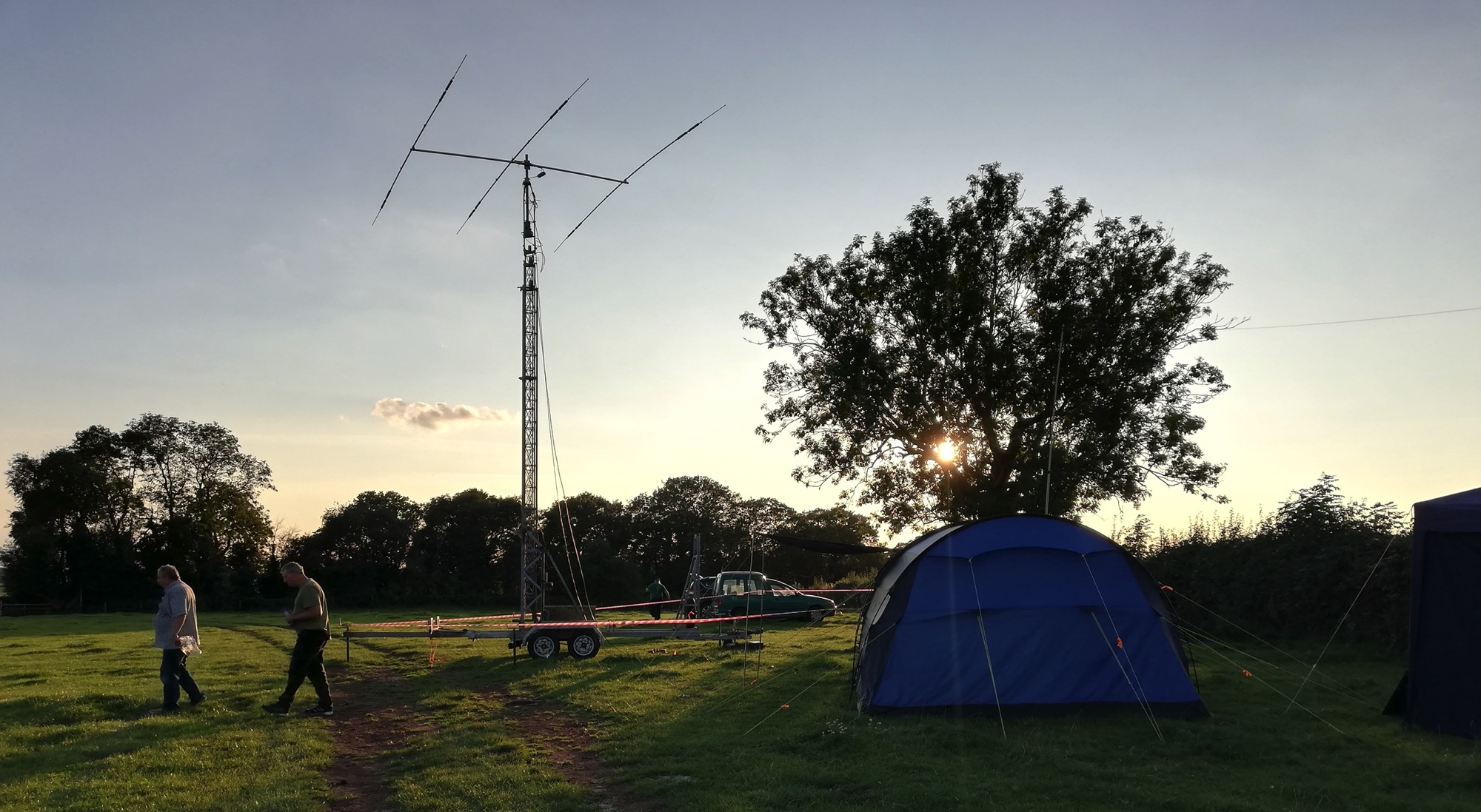 Portable amateur radio antennas and station at dusk